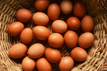 Brown eggs on a wicker basket background