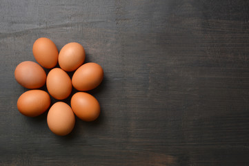 Daisy flower shaped with eggs on black background