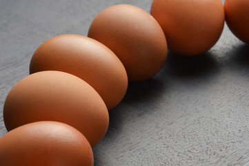 Group of eggs on the black wood background 