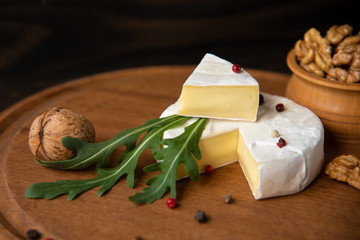 Cheese camembert or brie with walnuts and arugula
