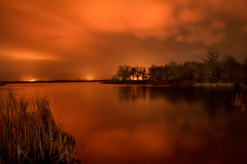 Naklejka na ściany i meble Fire in the floodlands on the river. Night photo. Dnieper River Delta.
