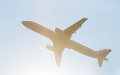 Passenger airliner is gaining altitude. Flight in the blue sky.