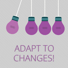 Word writing text Adapt To Changes. Business photo showcasing Innovative changes adaption with technological evolution Color Incandescent Pendant Bulb Hanging with One Different Shade Lightbulb