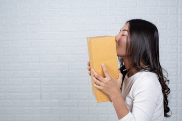 Woman holding a brown post box Made gestures with sign language.