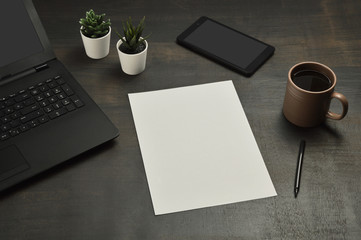 Office desk, laptop, empty note paper, digital tablet