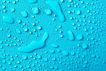 Drops of water on a blue glass texture background