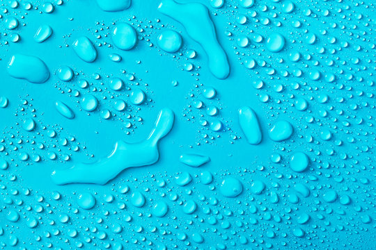 Drops of water on a blue glass texture background