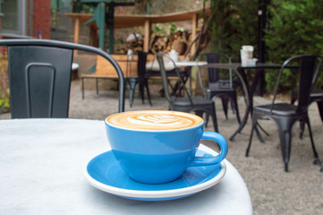 Cup of coffee, cappuccino on outdoor cafe table