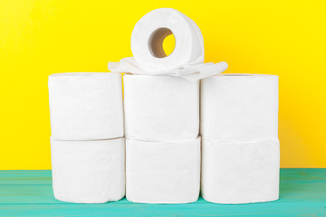 Toilet paper stacks  on bright yellow background