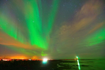 View of the northern light at Grotta Lighthouse in Reykjavik, Iceland.