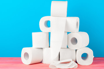 Toilet paper stack on bright blue background