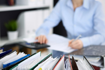 Unknown bookkeeper woman or financial inspector  making report, calculating or checking balance,...