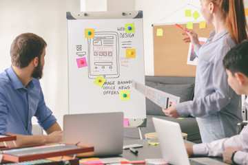 Young IT designers working in office