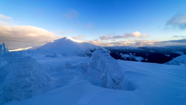 Late evening time Lapse footage of Snezka mountain in Krkonose NP, Czech Republic. Sunset over cold winter mountain landscape.