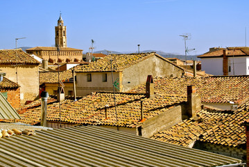 Tiled roofs of houses and the dome of the church. The color of the sand - typical for the Aragonese villages. Alcampell, Llitera, province of Huesca, Aragon, Spain