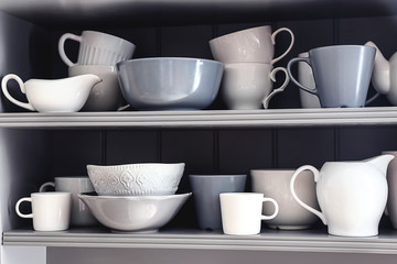 Fototapeta na wymiar Shelves with clean dishes in kitchen