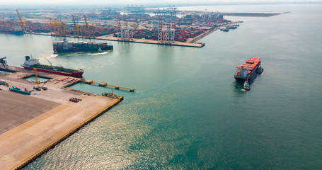 Container cargo ship an important transportation and Logistics Cargo containers on to the International port / Cargo ship - Cargo to harbor. Aerial view from drone