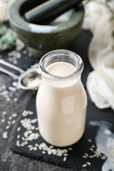 Bottle of healthy rice milk on table