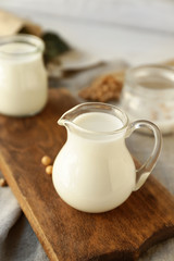 Obraz na płótnie Canvas Jug of healthy soy milk on table