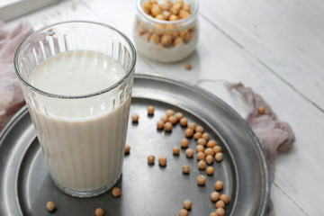 Glass of healthy soy milk on table