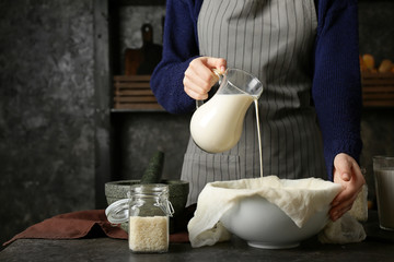 Woman making healthy rice milk in kitchen