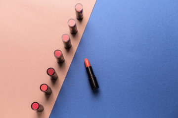 Many lipsticks on color background. Concept of uniqueness