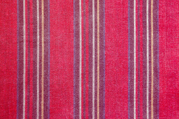 Texture of red vertically striped fabric. Background for design.