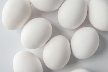 Tasty raw eggs on white background