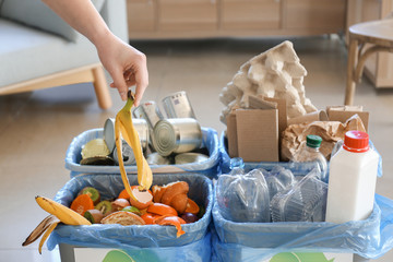 Woman sorting garbage indoors