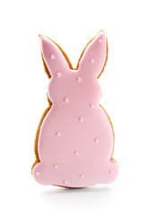 Tasty Easter cookie in shape of bunny on white background