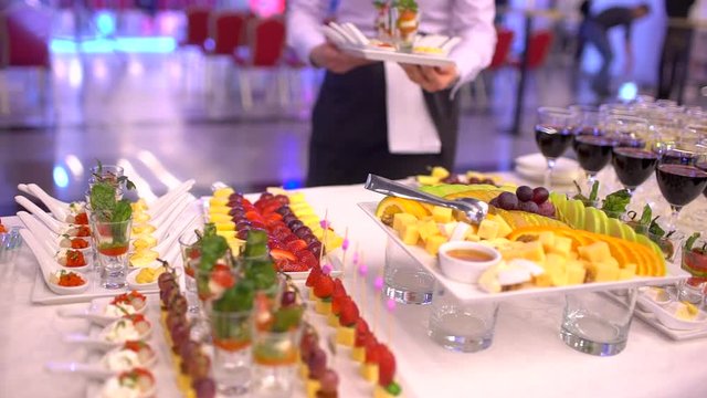 Beautifully decorated catering banquet table with snack canape in restaurant or hotel. catering service bisiness waiter buffet food set in event celebratoin corporate birthday kids party or wedding
