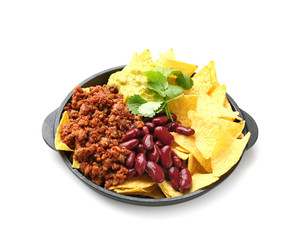 Frying pan with tasty nachos, minced meat, beans and guacamole on white background