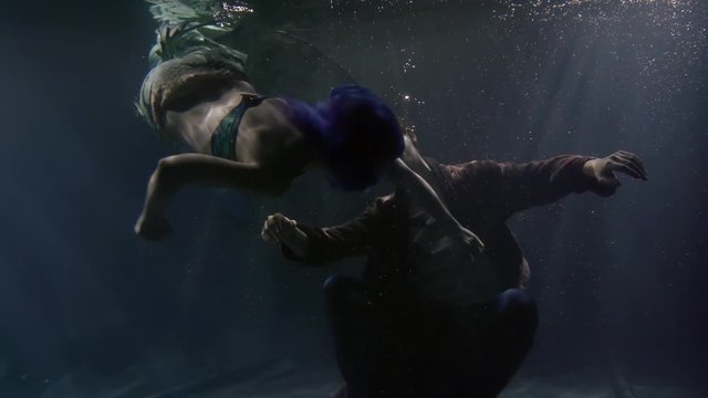 Mermaid finds dying man underwater.