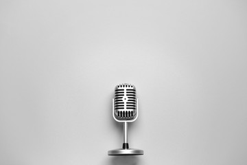 Retro microphone on light background