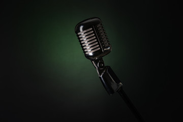 Fototapeta premium Retro microphone on dark color background
