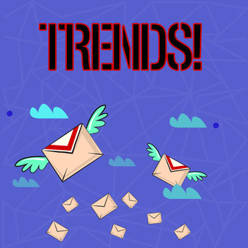 Writing note showing Trends. Business concept for General projected directions of something according to time Colorful Airmail Letter Envelopes and Two of Them with Wings