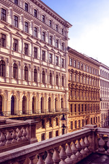 Fototapeta premium Austria, Vienna: Beautiful front view of typical apartment historical building facades in the city center of the austria capital illuminated by late afternoon sun light - concept architecture living