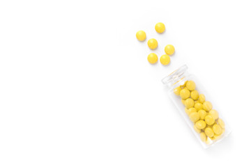 Yellow pills with glass bottle