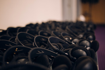A lot of headphones at the table 