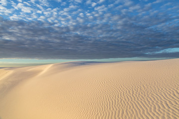Fototapeta na wymiar Clouds over White Sands Desert in New Mexico, at Sunrise