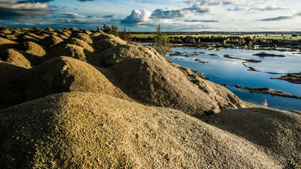 Sandy hills. Sandy canyon. Warm colors background. Yellow sandstone textured mountain, white thin...