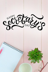 Open notebook with pink pen, coffee cup and succulent. Hand written lettering Happy Secretary's day
