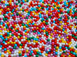 Fototapeta na wymiar close up of colorful eatable sugar pearls for food decoration