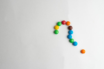 Colorful chocolate candies on the white background