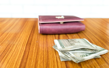 Indian five hundred (500) rupee cash note in brown color wallet leather purse on a wooden table. Business finance economy concept. Side angel view with copy space room for text on left side of image.