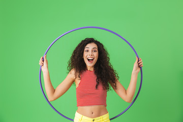 Photo of energetic woman 20s wearing summer clothes doing exercises with hula hoop during gymnastics