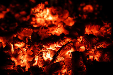 Hot coals in fireplace, fire background, close-up, macro.