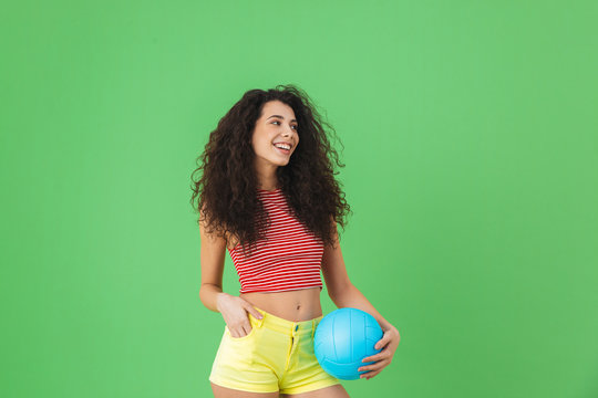 Image of caucasian woman 20s wearing summer clothes smiling and holding volley ball