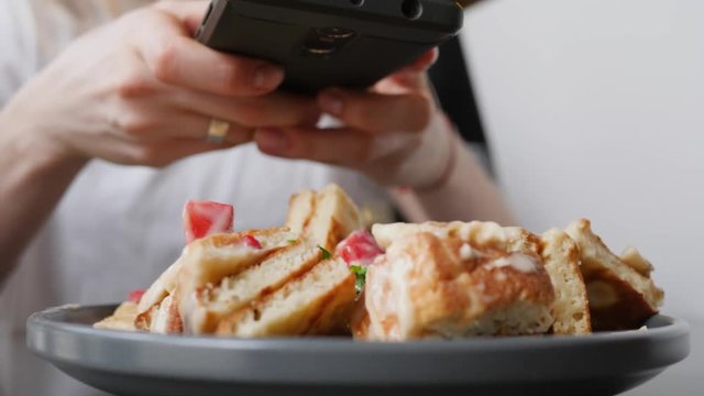 Young girl hands hold mobile taking food photo via smartphone camera for social media