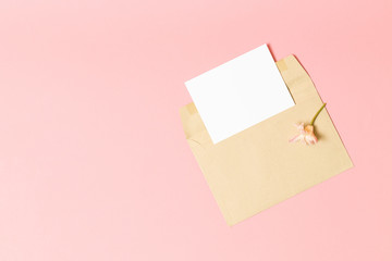 Pink envelope with a spring flower arrangement.